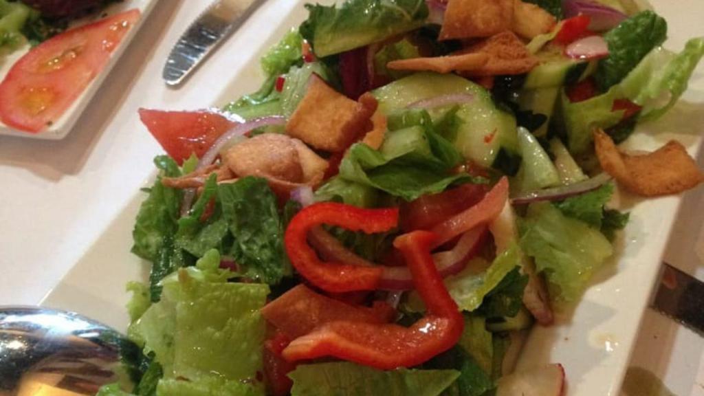 Fattoush Salad · Lettuce, tomato, cucumber, pita chips, onion, parsley, dry mint, lemon juice, olive oil and sumac.