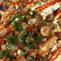 Sisig California Fries · Golden fries with shredded cheese, Orange sauce, Sour cream, Topped with sriracha and green ...