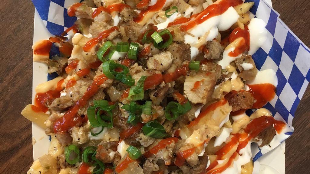 Sisig California Fries · Golden fries with shredded cheese, Orange sauce, Sour cream, Topped with sriracha and green onions.