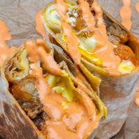 Sausage Burrito · 3 fried eggs, choice of sausage, tater tots, white american cheese, caramelized onions, spic...