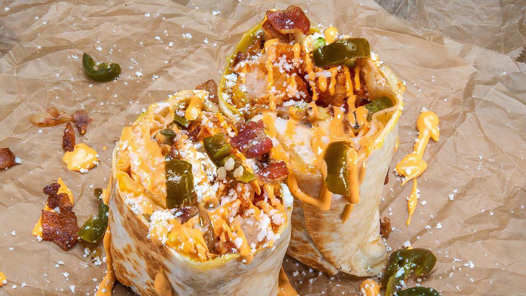 Little Mule Burrito · 3 fried eggs, smoked bacon, white American cheese, avocado, pickled jalapeños, crispy tater tots, cotija cheese, chipotle aioli; sides of spicy mayo and hot sauce.