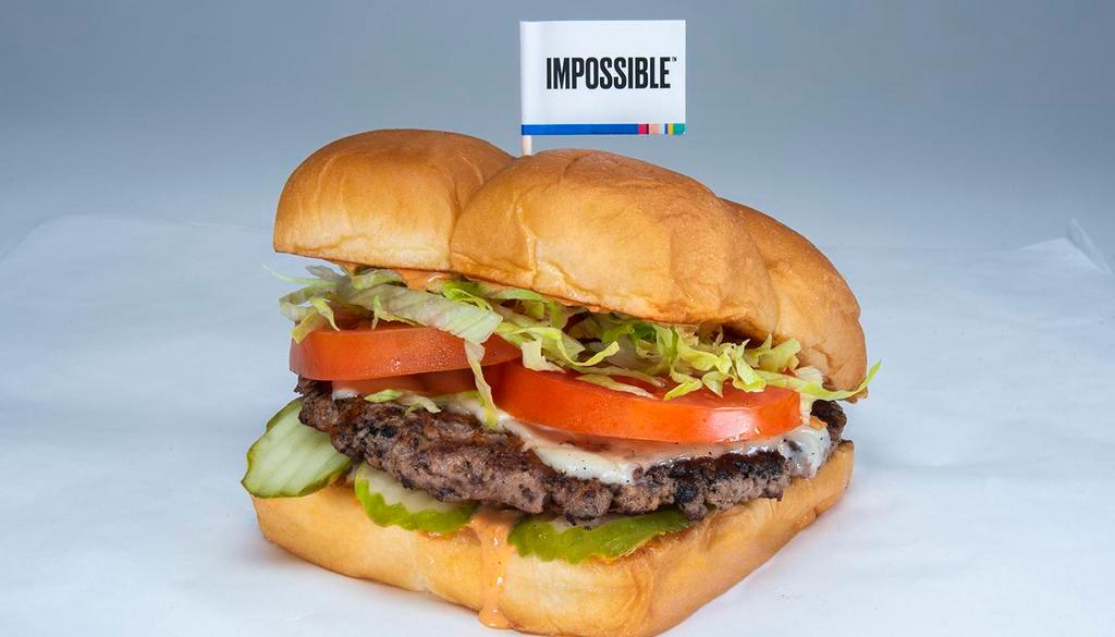 Impossible Burger · Impossible patty, pickles, lettuce, tomato, onion, white American cheese, and secret sauce. Served on King’s Hawaiian roll.