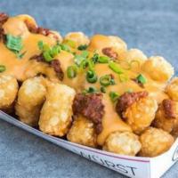 CHILI CHEESE TOTS · tots, cheddar cheese sauce, haus chili, green onions
