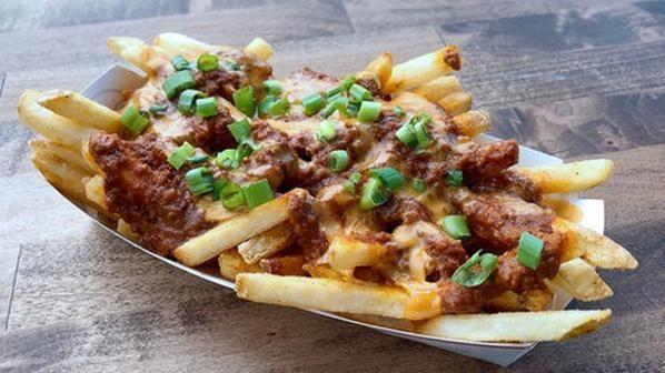 CHILI CHEESE FRIES · fries, cheddar cheese sauce, haus chili, green onions