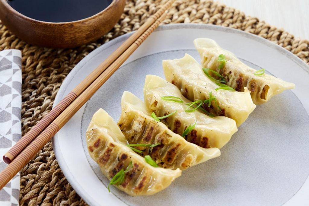 Pork Gyoza · Spicy sesame soy dipping sauce.