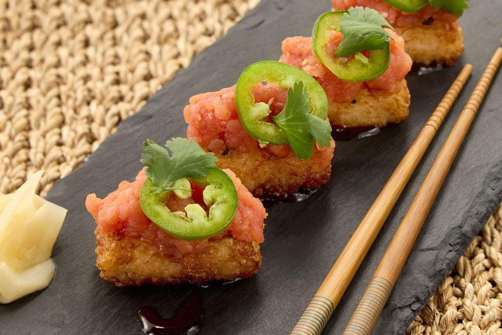 Crispy Spicy Tuna* · Crunchy sesame rice balls, jalapenos, cilantro, drizzled with soy chili sauce.