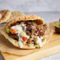 Pita Beef Kebab · Ground beef and lamb kebab, hummus, cucumber, tomato, pickles and tahini (gf)