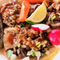 Sopes · 2 thick tortillas with vegetable toppings and choice of meat topping.