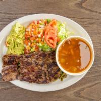 Carne Asada · All dinner plates are served with rice and refried beans. Grilled skirt steak, refried beans...