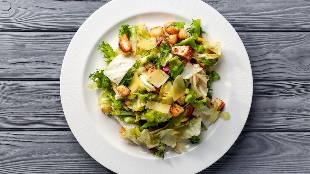 Caesar Salad · Crispy romaine lettuce topped with herb croutons and fresh grated parmesan cheese, served with a side of creamy caesar dressing.
