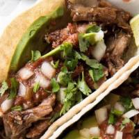Carnitas Taco · Pork Tacos topped off with Cilantro and Onions.