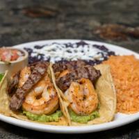 Surf and Turf Tacos (2) · Mexican style shrimp sautéed in garlic butter, flap steak, guac, black beans, rice