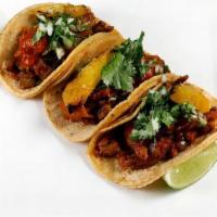 Tacos Al Pastor (3) · Marinated pork, salsa roja, roasted pineapple, onion and cilantro