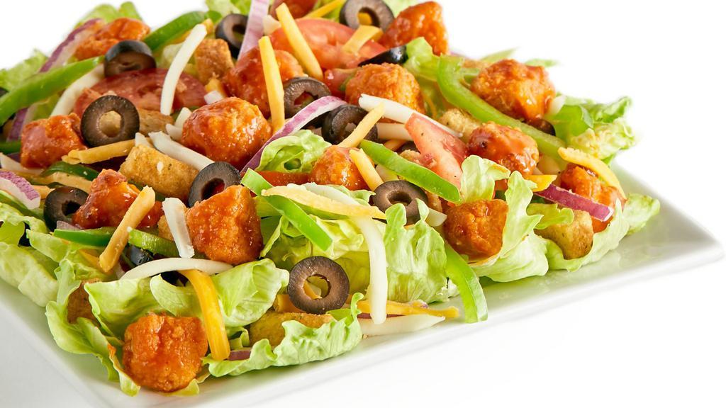 Buffalo Chicken Salad · Iceberg Lettuce, Buffalo Chicken, Bell Peppers, Red Onions, Black Olives, Fresh Roma Tomatoes, Mozzarella Cheese, Cheddar Cheese, Seasoned Croutons, and Ranch or your choice of dressing.