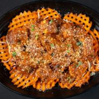 Sexy Fries · An Indian-inspired poutine: sweet potato fries topped with cheese and tikka masala with choi...