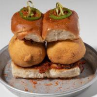 Vada Pav · Mashed potato fritters, garlic chutney, and bombay dust sandwiched between Amul-buttered, to...