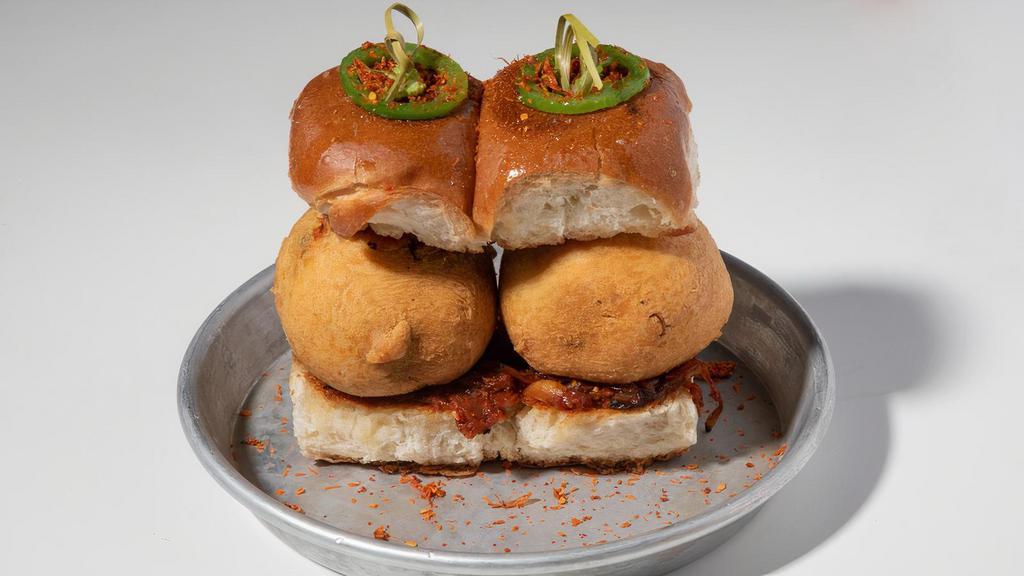 Vada Pav · Mashed potato fritters, garlic chutney, and bombay dust sandwiched between Amul-buttered, toasted buns. Vegetarian