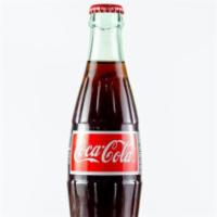 Mexican Coke · Iconic refreshing cola.