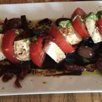 Caprese Platter · Fresh mozzarella and local tomatoes, kalamata olives, homemade dressing ,pesto.
Served with ...
