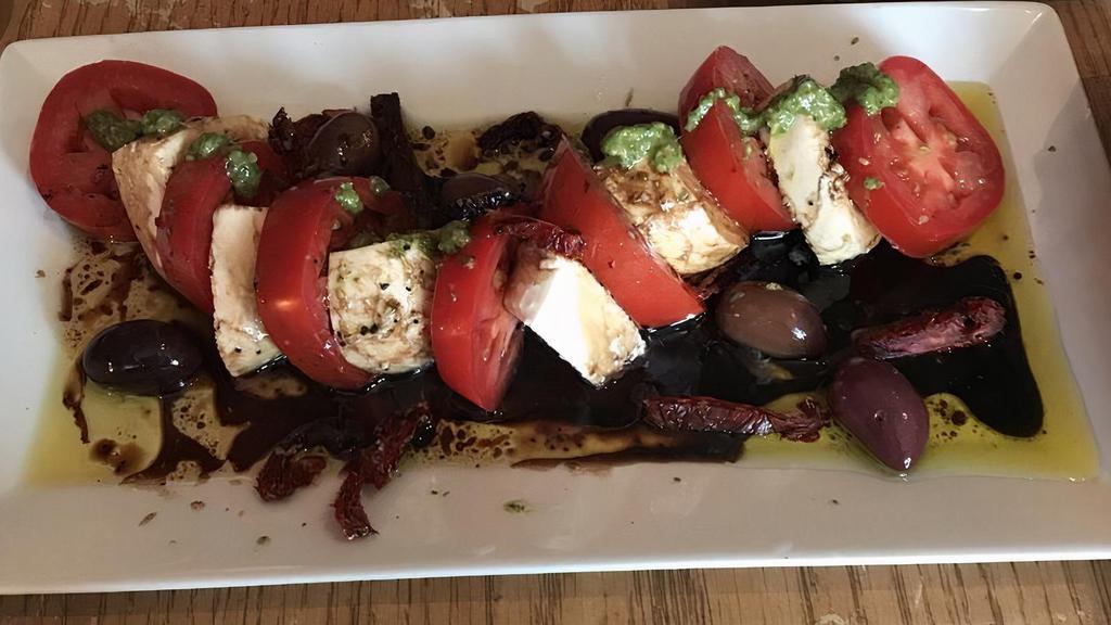 Caprese Platter · Fresh mozzarella and local tomatoes, kalamata olives, homemade dressing ,pesto.
Served with local bread