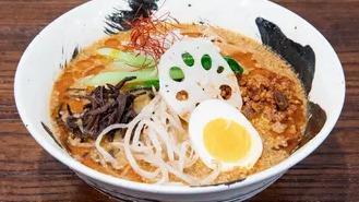 Tantanmen · Our creamy sesame based tonkotsu broth topped with spicy ground pork, marinated soft-boiled egg, lotus root, bamboo shoot, black mushroom, bokchoy, bean sprouts, and onion leek.
