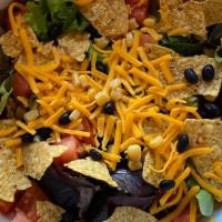 Tostada · House mix greens,roasted corn,black beans, tomatoes, herbs, tortilla chips, avocado,cheddar ...