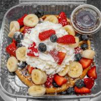 Fruit Waffle · Strawberries, blueberries, banana, powdered sugar, and whipped cream.