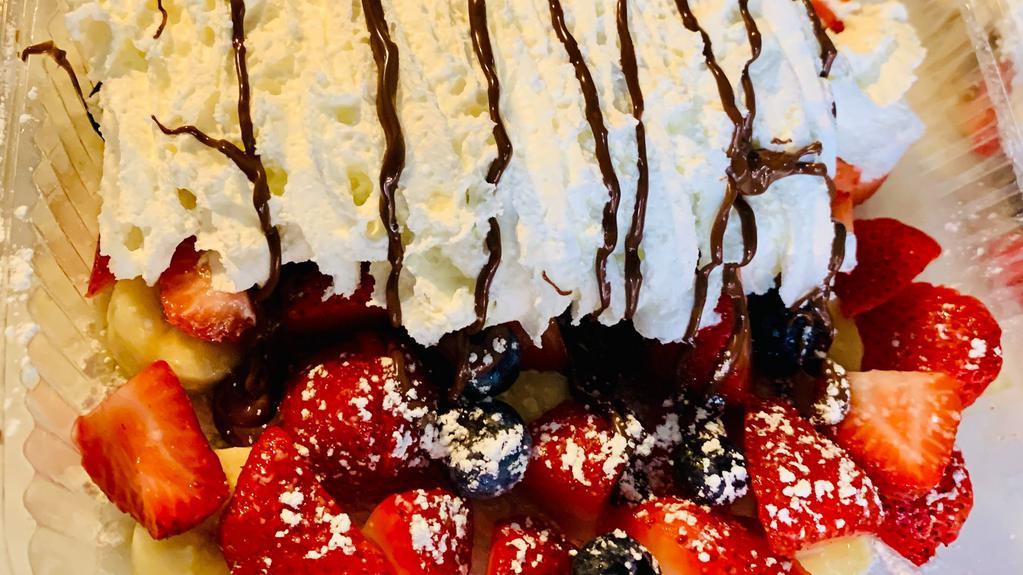 Fruit Nutella Crepe · Nutella, strawberries, blueberries, banana, powdered sugar, and whipped cream.