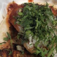 Grilled Fish Taco · Grilled tilapia, griddled corn tortillas, onions, cilantro, salsa casera.