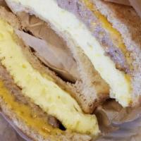 Breakfast Sandwich · 2 scrambled eggs, cheese and meat (ham or bacon or sausage).