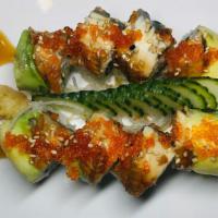 Dragon Roll · Shrimp tempura and cucumber, topped with eel, avocado, tobiko, sweet sauce, and sesame seeds.