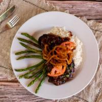 Grilled Rib Eye Steak  with Whiskey Pepper Sauce · Seasoned with peppercorn and topped with a whiskey glaze, mushrooms, sautéed asparagus and F...