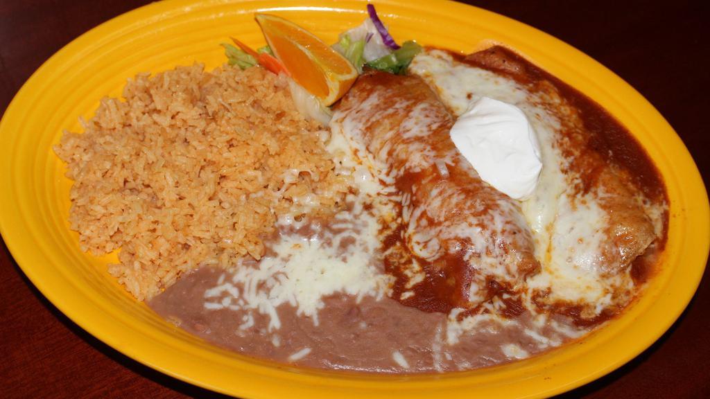 12. Red Enchiladas · Two corn tortillas stuffed with your choice of meat or cheese. Served with rice and refried beans topped with cheese.