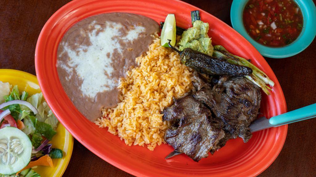 Carne Asada · Tender juicy steak, grilled to your taste. Includes salad, grilled onions and guacamole.
Served with rice, beans, salad and tortillas.