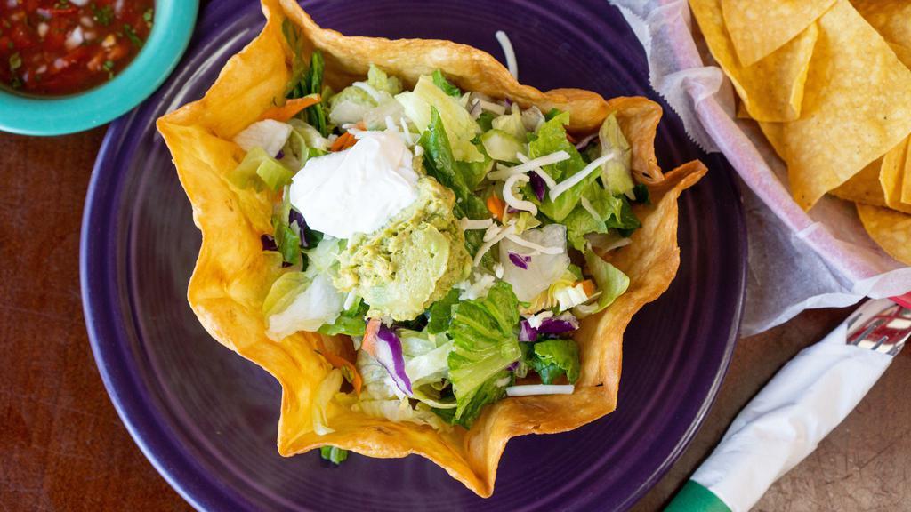 Taco Salad · Choice of meat. With rice, whole beans, sour cream and guacamole.