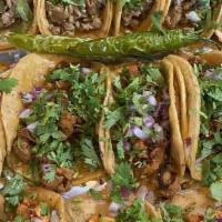El Patio Street Tacos Platter · Four delicious guadalajara style tacos topped with meat, whole beans, cilantro, onion and a ...