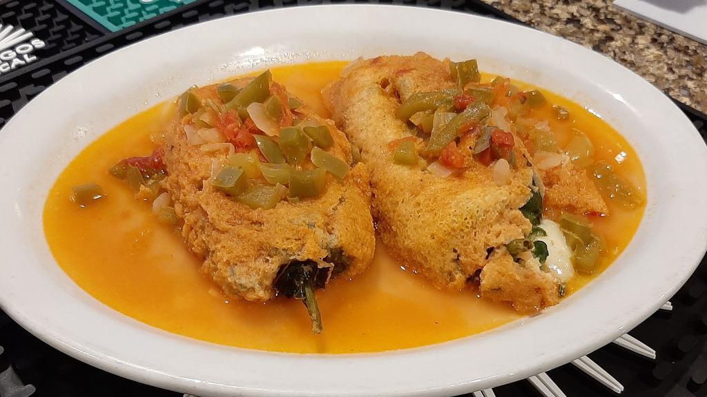 Chile Relleno · Mild green Chile stuffed with melted monterey jack cheese, dipped in egg batter, fried ‘till golden and sautéed in a tomato and onion sauce.