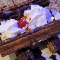 Churros · Mini churros arranged along side vanilla ice cream. Garnished with whipped cream, caramel an...