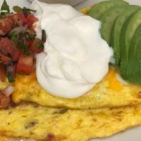 Tostada Style Omelet · Bacon, green chilies topped with sour cream, salsa, avocado, and mix cheese.