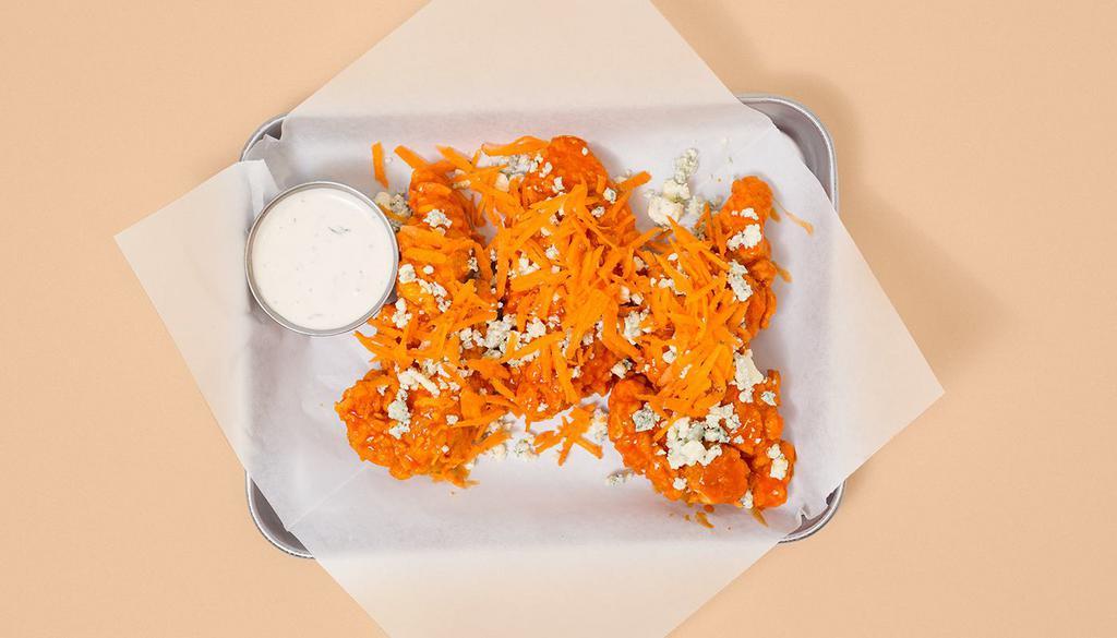 Buffalo Tenders · Three crispy fried chicken tenders drenched in buffalo sauce with funky blue cheese crumbles, shredded carrots, and your choice of dipping sauce