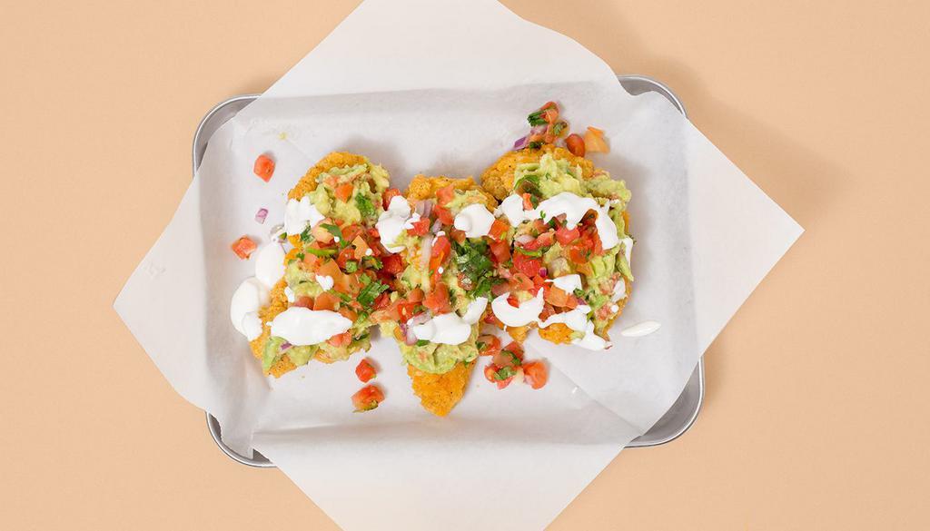 Southwestern Tenders · Three crispy fried chicken tenders layered with guac, pico de gallo, sour cream, plus your choice of dipping sauce