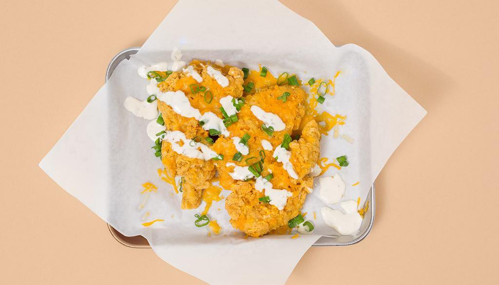 Cheese Tenders · Three crispy fried chicken tenders covered with cheese, scallions, and ranch. Comes with your choice of dipping sauce