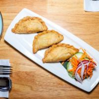 Curry Puff · Deep-fried pastry shell stuffed, curry powder, and potatoes served with a side of cucumber s...