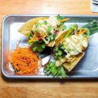 Fish Tacos · Crispy whitefish, mixed greens, red onions, carrots, and cilantro topped with seafood mayo w...
