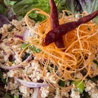 Larb Kai · Ground chicken, red and green onions, cilantro, and roasted rice powder tossed with various ...
