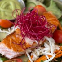 Grilled Salmon Salad · Grilled salmon over mixed greens, carrots, cucumbers, tomatoes, and cheese tossed with a Jap...