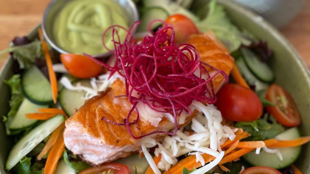 Grilled Salmon Salad · Grilled salmon over mixed greens, carrots, cucumbers, tomatoes, and cheese tossed with a Japanese-style dressing.