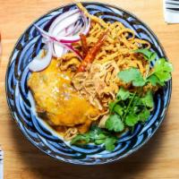 Kao Soi · Egg noodles in a northern thai-style curry served with a juicy and tender chicken thigh, pic...