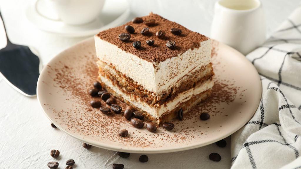 Tiramisu · A coffee-flavored Italian dessert made with ladyfingers dipped in coffee and layered in a whipped mixture of eggs, sugar and mascarpone cheese with a cocoa dusting.