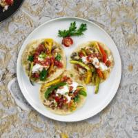 Veggie Medley Taco · Spinach tortillas, vegan cheese, beans, rice, lettuce, guacamole, vegan sour cream and salsa.